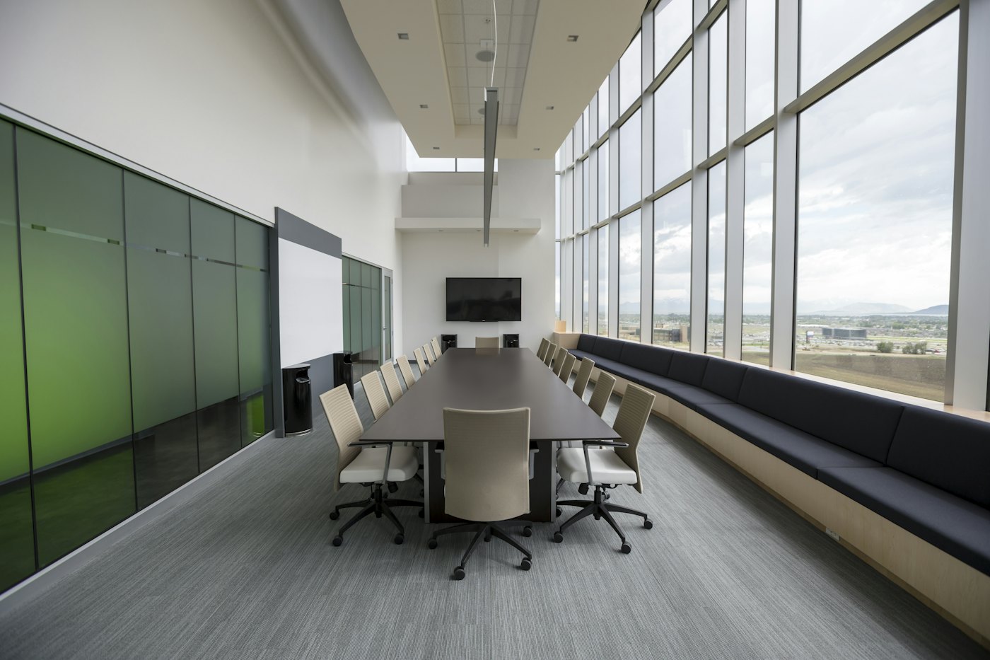 An empty conference room with a long table and chairs